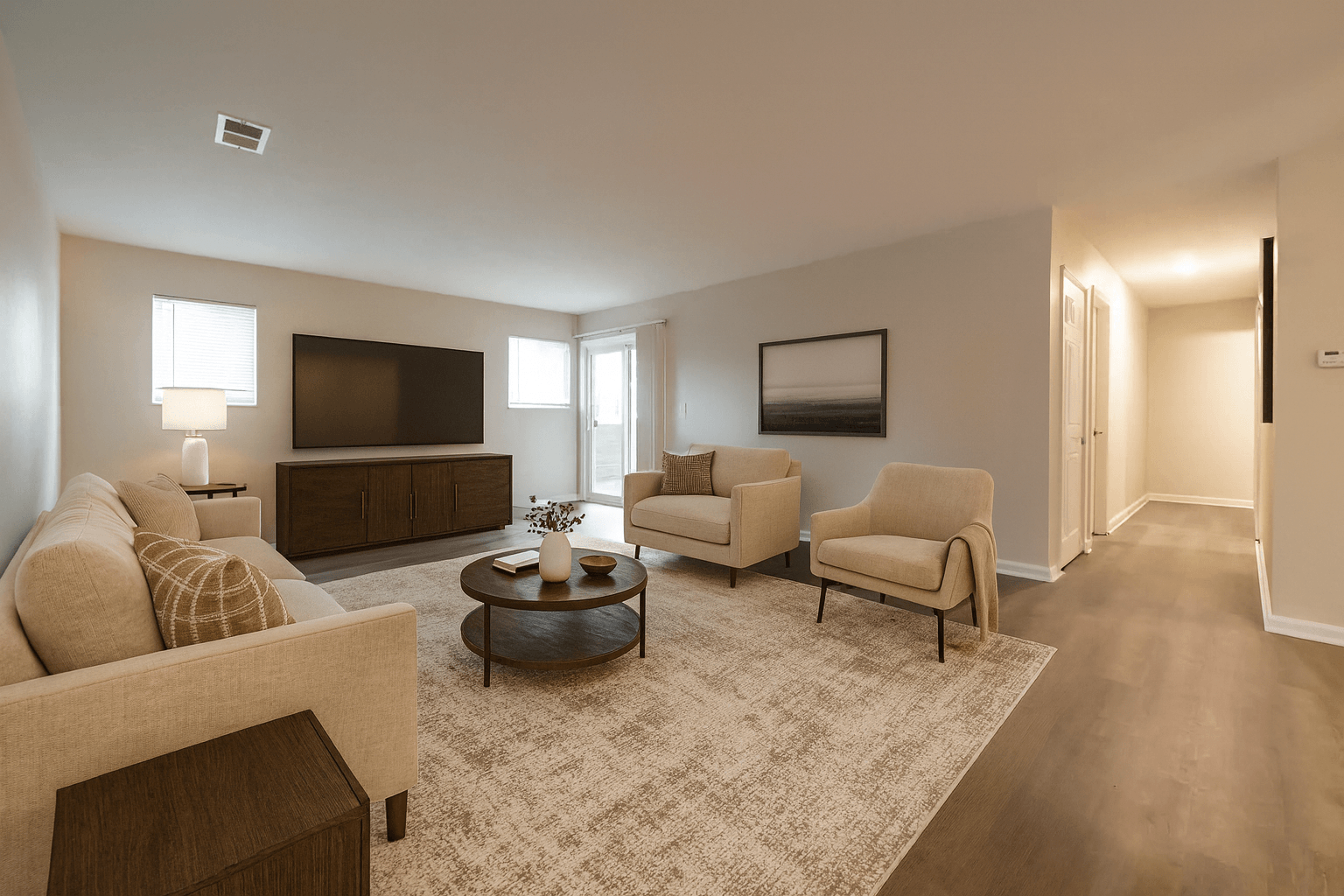 A living room with a couch, chairs, and a coffee table.